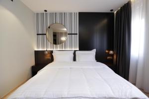Postel nebo postele na pokoji v ubytování Gremmy Boutique Hotel