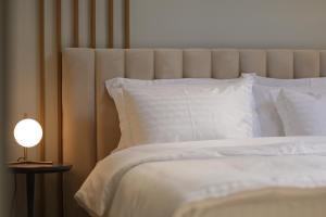 Postel nebo postele na pokoji v ubytování Gremmy Boutique Hotel