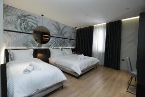 Postel nebo postele na pokoji v ubytování Gremmy Boutique Hotel