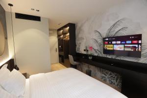 Postel nebo postele na pokoji v ubytování Gremmy Boutique Hotel