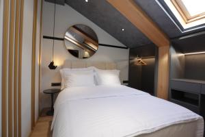 Postel nebo postele na pokoji v ubytování Gremmy Boutique Hotel