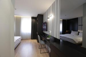 Postel nebo postele na pokoji v ubytování Gremmy Boutique Hotel