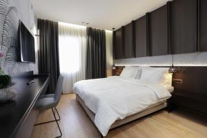 Postel nebo postele na pokoji v ubytování Gremmy Boutique Hotel
