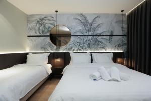 Postel nebo postele na pokoji v ubytování Gremmy Boutique Hotel