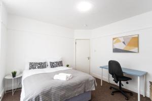 a bedroom with a bed and a desk and a chair at April Disc - Long Stay - Contractors in Bristol