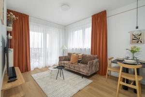 a living room with a couch and a table at Unique 2-Bedroom Apartment on the 10th Floor with FREE GARAGE Poznań by Renters in Poznań