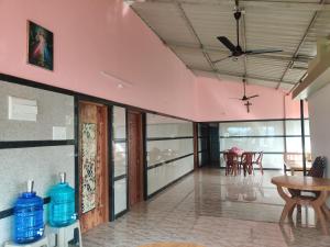 uma sala de estar com uma ventoinha de tecto e uma mesa em Trinity Villa - Home Stay em Honāvar