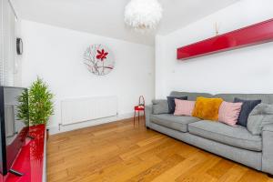 a living room with a couch and a table at Newly refurbished 2BR wbalcony in Vibrant Peckham in London