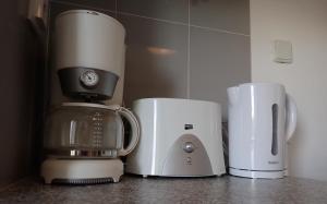 a blender and a coffee maker on a counter at Great value 5 mins to Praia de Rocha beach in Portimão