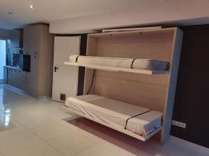 two bunk beds in a room with a kitchen at Playa 4 a solo 3 min - Apartamento en Castelldefels in Castelldefels