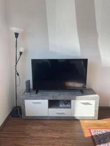 a entertainment center with a flat screen tv on it at Düs Apartment 2 in Düsseldorf
