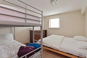 1 Schlafzimmer mit 2 Etagenbetten und einem Fenster in der Unterkunft Harbour View 2a 2ev in Zeebrugge