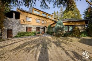 a house with a stone driveway in front of it at Casa Torre de les Àligues in Bellver de Cerdanya 