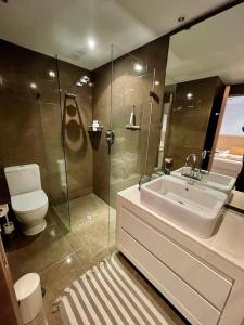 a bathroom with a sink and a toilet and a shower at Coastal Comfort in Puerto Sotogrande in Torreguadiaro
