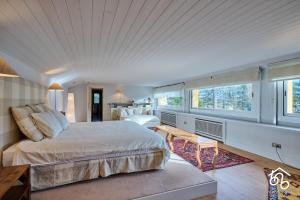 a bedroom with a bed and a table and windows at Casa Torre de les Àligues in Bellver de Cerdanya 