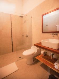 a bathroom with a shower and a toilet and a sink at La Casa Amarilla in Mompos