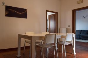 a dining room with a table and chairs at Rooftop Madreperla in Taranto +17 photos