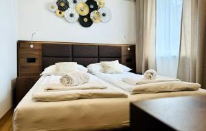 a bedroom with a large bed with towels on it at Apartments & rooms Artemus Belveder in Koper