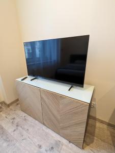 a large flat screen tv sitting on top of a cabinet at Apartament #3 in Downtown of Krakow in Krakow