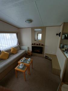 a living room with a couch and a table at Laurel 20 holidayhome in Rhyl