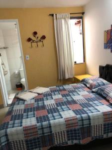 Ένα ή περισσότερα κρεβάτια σε δωμάτιο στο Doce lar aconchegante