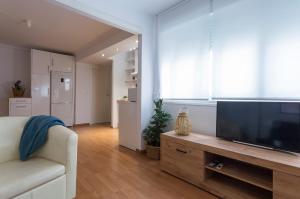 a living room with a large flat screen tv at Centrico Tranquilo 2 dormitorios in Jerez de la Frontera +7 photos