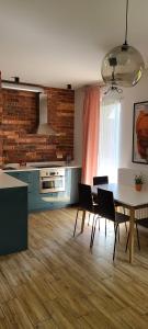 a kitchen and dining room with a table and chairs at Lovely One-Bedroom Condo With Patio. in Warsaw