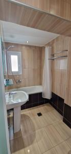 La salle de bains est pourvue d'un lavabo et d'une baignoire. dans l'établissement Adele Resort, à Adelianos Kampos
