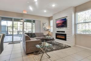 a living room with a couch and a fireplace at Summer Breeze Villa in Davenport