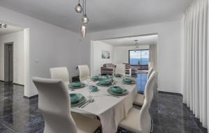 a white dining room with a table and chairs at 2 Bedroom Beautiful Apartment In Lovran in Lovran
