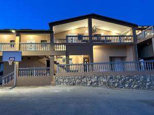 a large apartment building with a basketball hoop at Holiday Home Robert 2 with pool in Cesarica