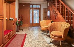 a waiting room with three chairs and a staircase at Großes Ferienhaus In Oberwoelz in Oberwölz Stadt