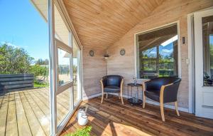 two chairs on the porch of a tiny house at Holiday Home Lakolk Xii Denmark in Bolilmark
