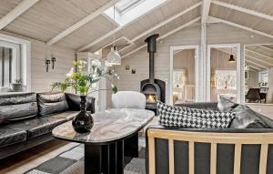 a living room with a couch and a table at Holiday Home Lakolk Xii Denmark in Bolilmark