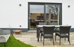 a patio with a table and chairs in a yard at Gorgeous Apartment In Attendorn in Attendorn +10 photos