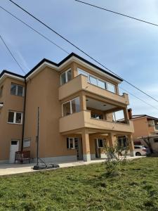 a building on a street with a green yard at Trsat-Kampus apartments in Rijeka