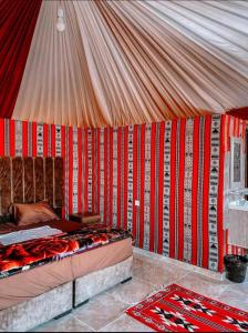 a room with a bed in a tent at RUM MAGiC lUXURY CAMP in Wadi Rum