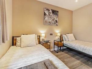 a bedroom with two beds and a table at 2 Bed in Heyope 94202 in Knighton