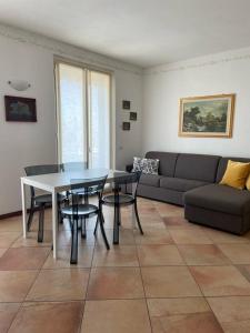 a living room with a table and a couch at The Little Eagle - Apartment with Terrace in Argegno