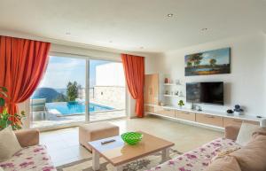 a living room with a view of a pool at Villa Eslem in Kas