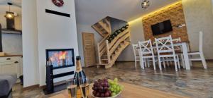 a living room with a table with a bowl of fruit at Domki 4 pory roku in Koniaków