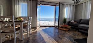 a living room with a couch and a table with a view at Domki 4 pory roku in Koniaków