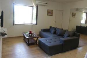 a living room with a couch and a coffee table at Beachfront apartment Drazen, with garden in Split