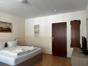 a bedroom with a bed and a television in it at Schwanen-Resort in Baiersbronn