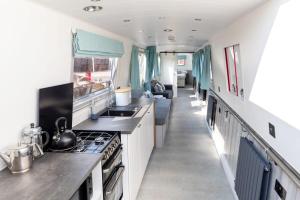 an rv kitchen with a sink and a stove at The Jubilee Narrow Boat in Loughborough
