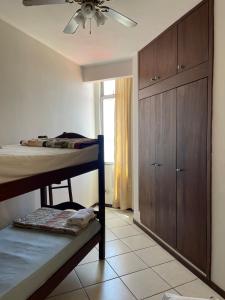 a bedroom with a bunk bed and a ceiling fan at Manga Rosa Suites in Salvador