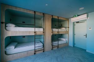 a room with three bunk beds in it at The Boc Hostels - Beach in Can Pastilla