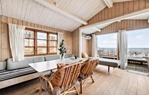 a dining room with a table and chairs at Beautiful Home In Dronningmlle With House Sea View in Dronningmølle