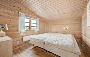 a bedroom with a bed in a wooden room at Beautiful Home In Dronningmlle With House Sea View in Dronningmølle