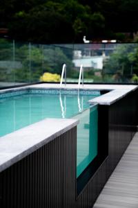 a swimming pool with two fins on the side of it at Zar in Amanzimtoti